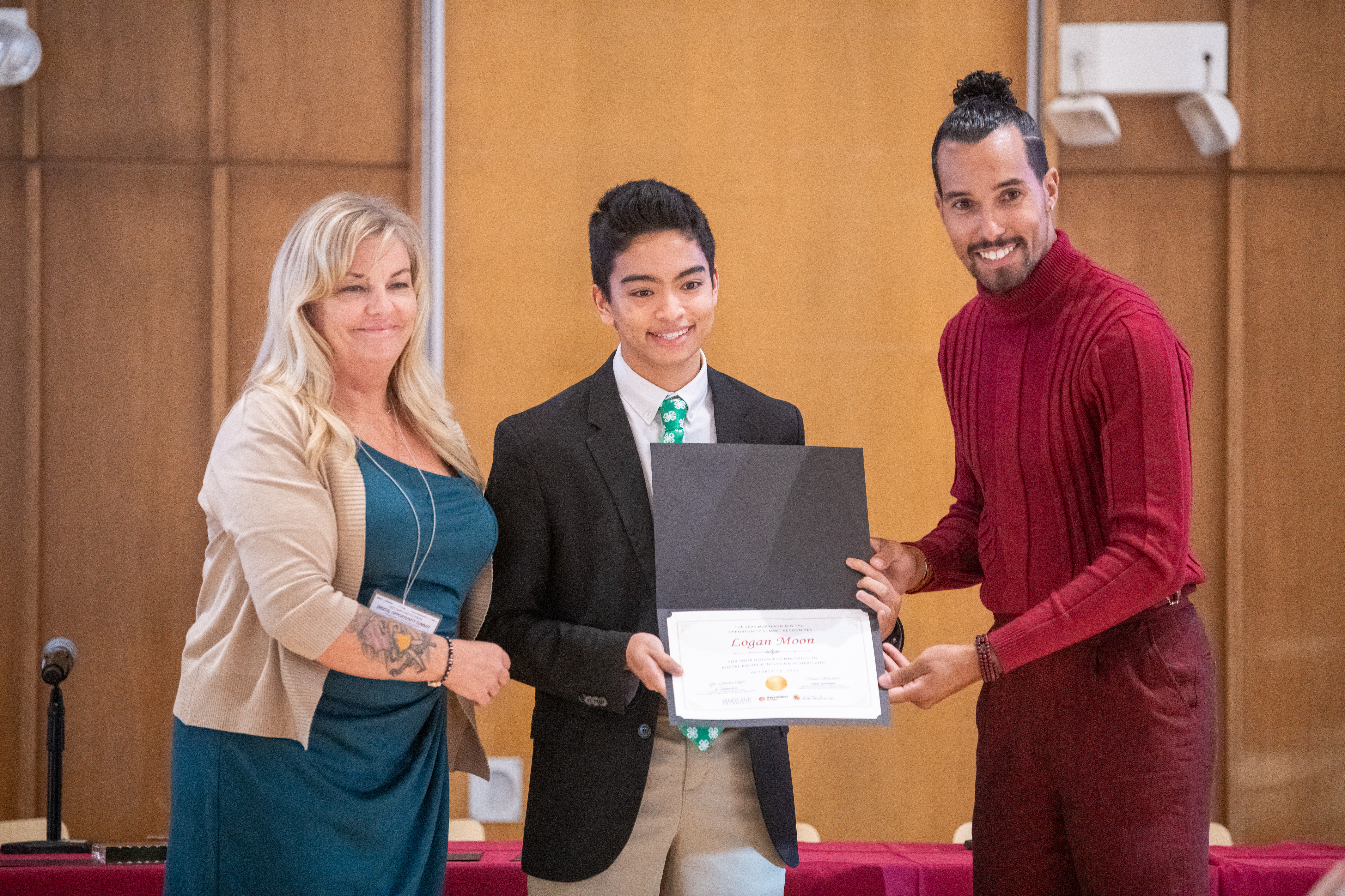 Pictured: Logan Moon, a senior at Calvert Hall High School, accepts the Practitioner Notable Mention Award at the 2025 Maryland Digital Opportunity Summit.