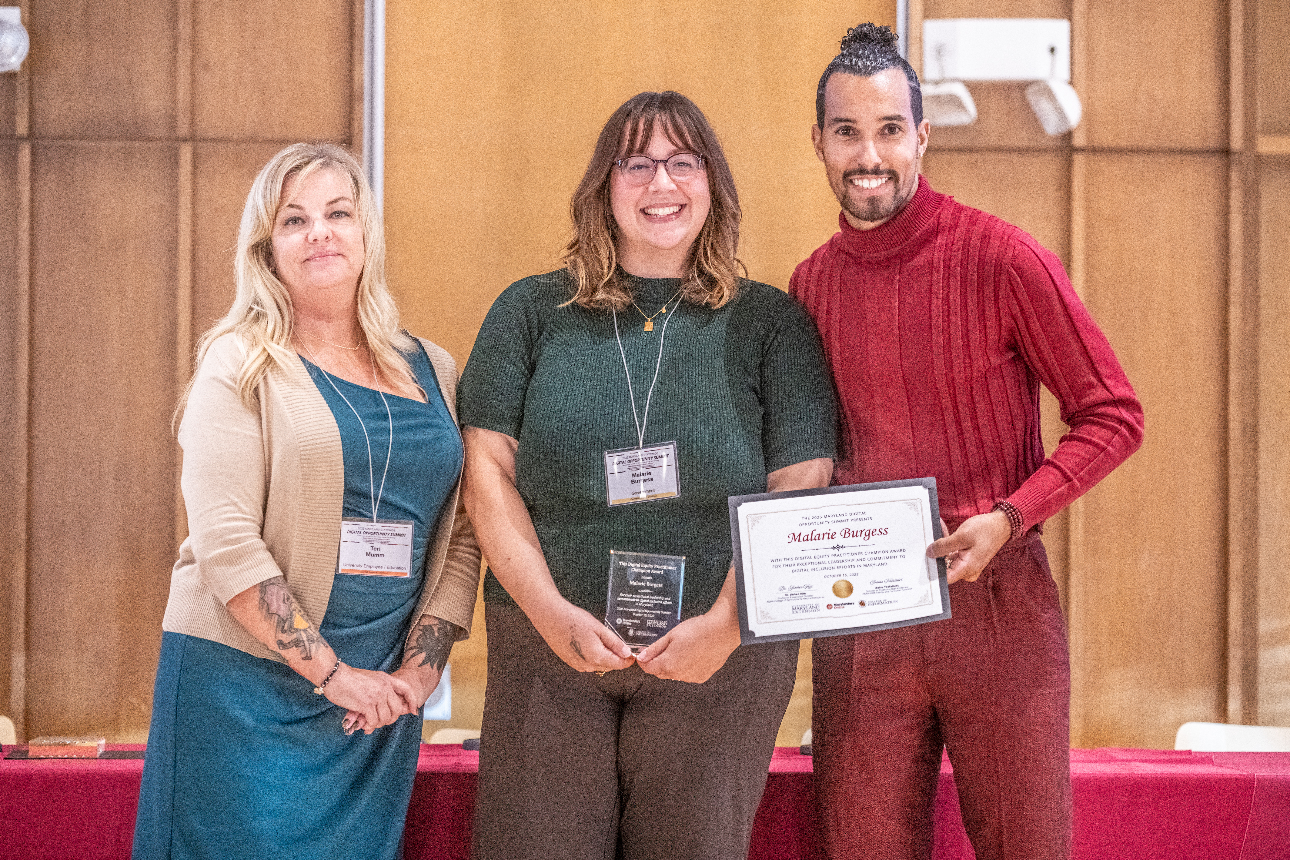 Pictured: Malaria Burgess accepts the Practitioner Award alongside Teri Mumm (left) and Ronnie Hammond (right).